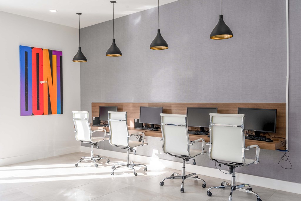 a conference room with white chairs and a colorful painting on the wall