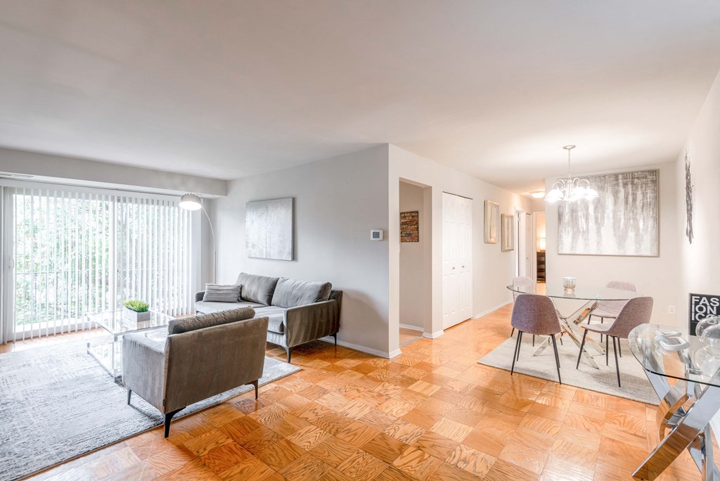 a living room with a couch and a table and a dining room