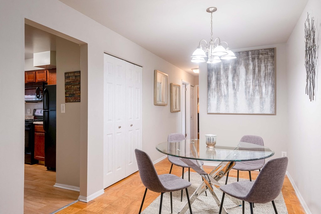 a dining room with a glass table and chairs