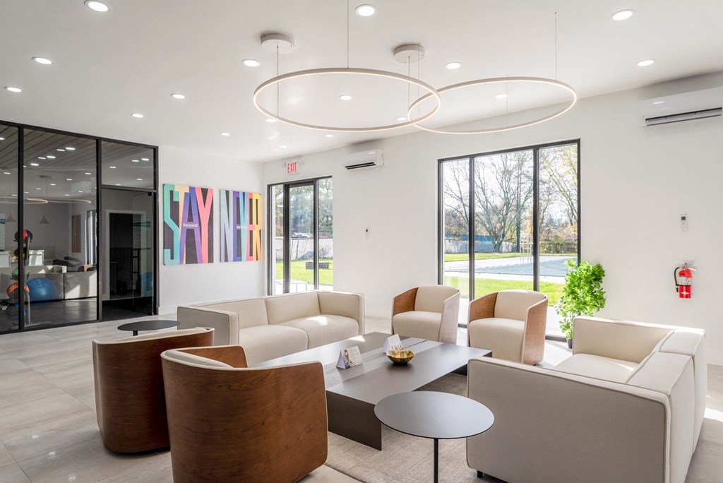 a living room with couches and chairs and a table