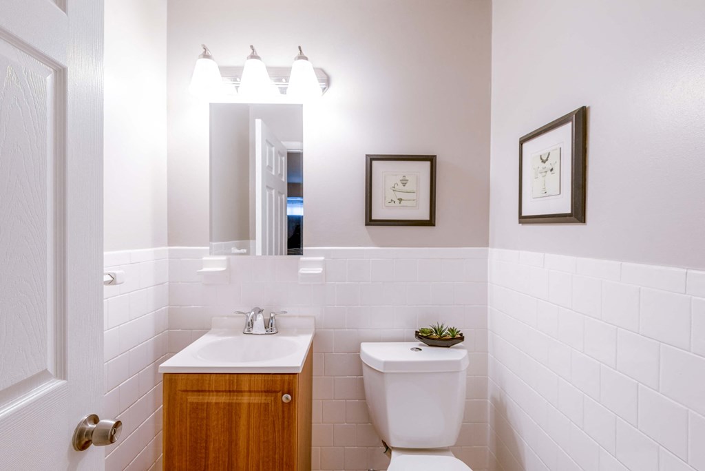 a bathroom with a toilet sink and a mirror