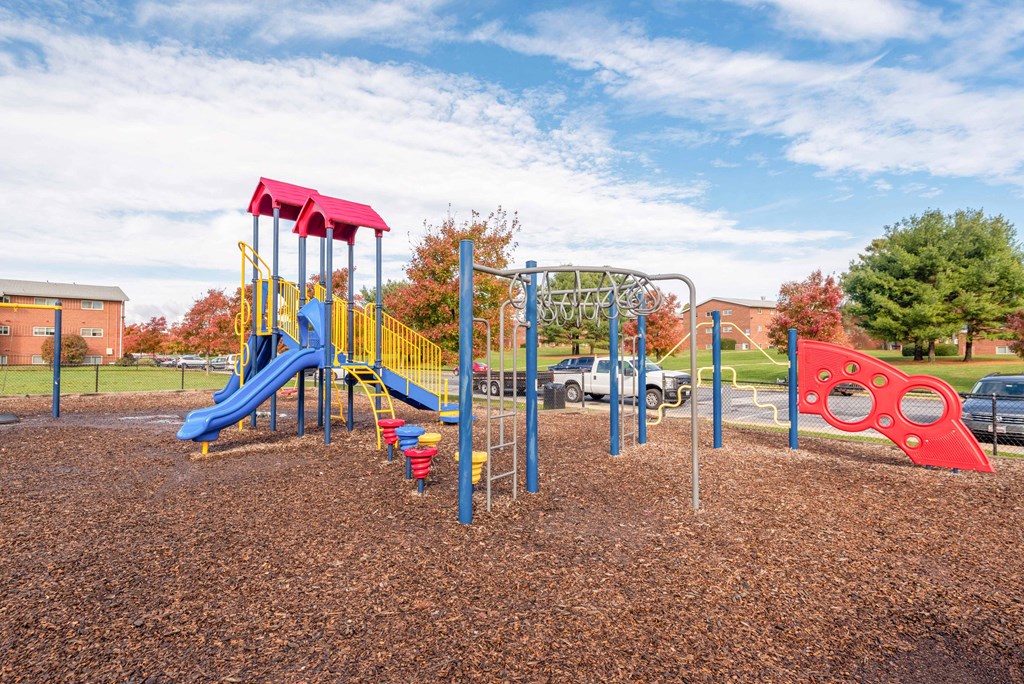 a playground with a colorful assortment of playground equipment in a park