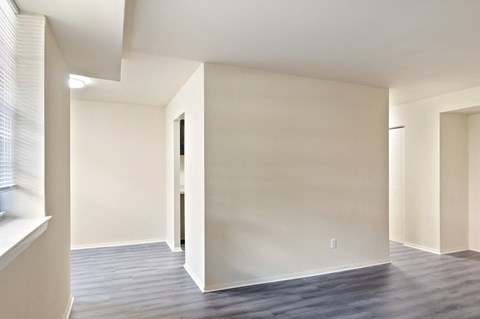 A room with a door and a window with blinds.