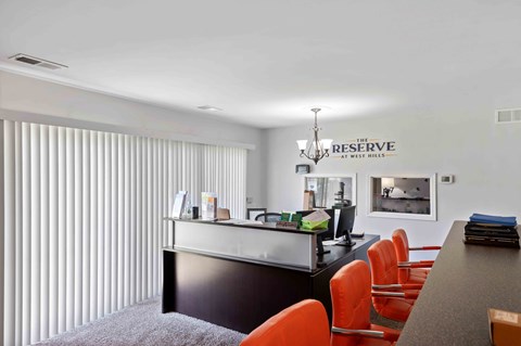 A reception area with a desk and chairs.
