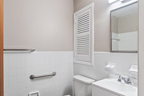 A white toilet sits next to a sink in a bathroom.