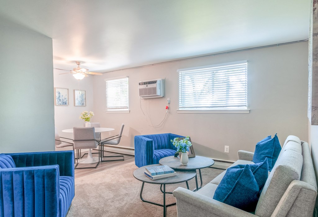 a living room with couches and chairs
