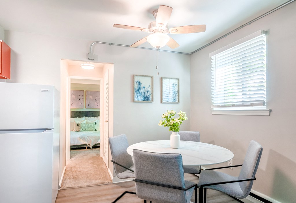 a dining room with a table and chairs and a ceiling fan
