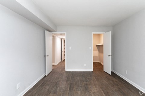 a renovated living room with white walls and wood floors