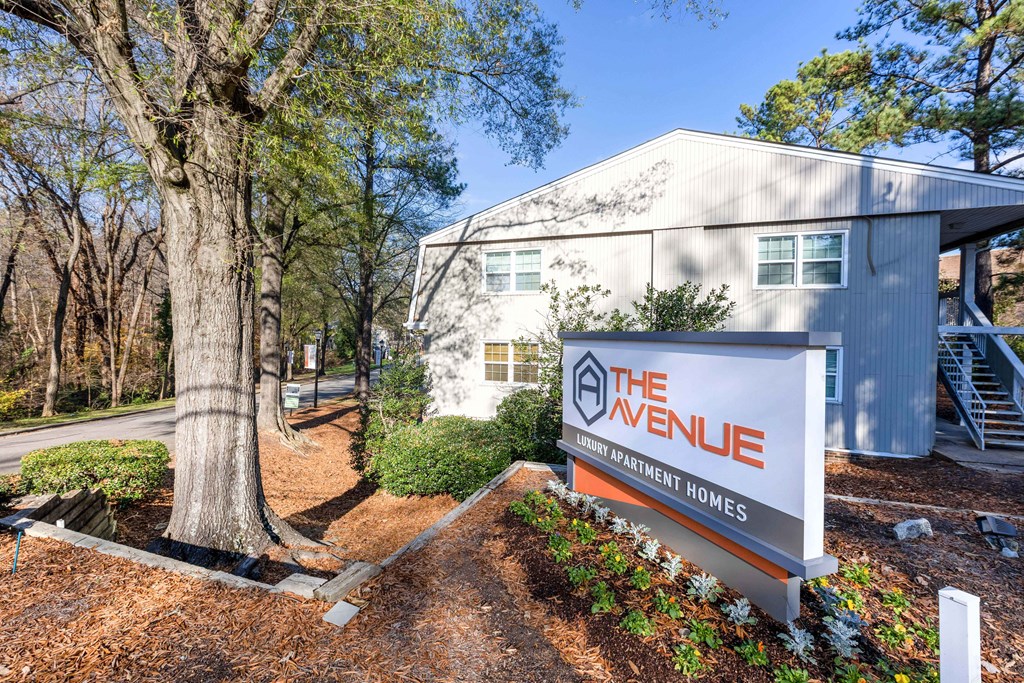 the exterior of the avenue apartments with a sign for the avenue