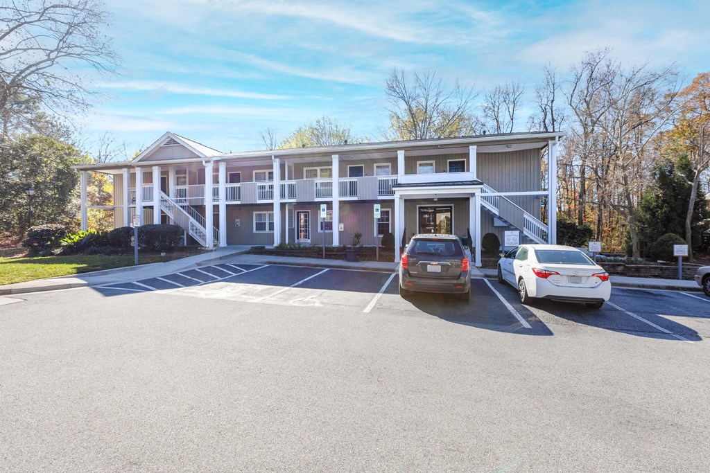 a large white building with cars parked in front of it