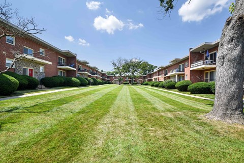 a large lawn in front of an apartment building