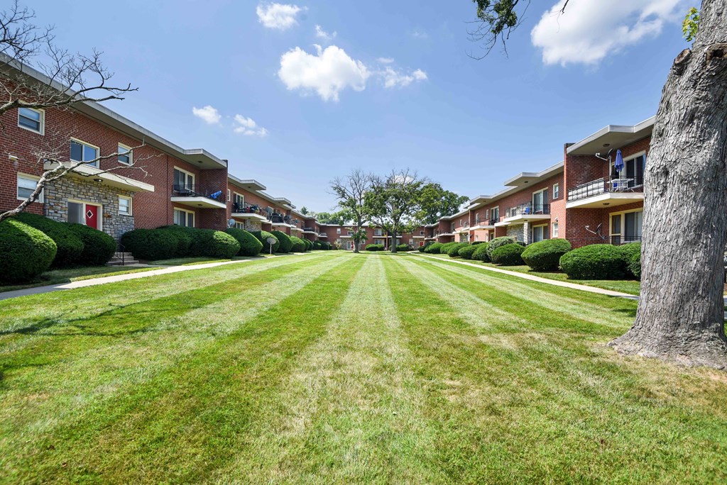 a large lawn in front of an apartment building