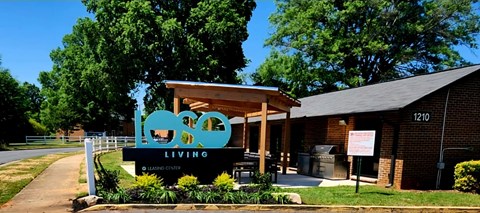 A building with a sign that says "LOVE LIVING" in front of it.