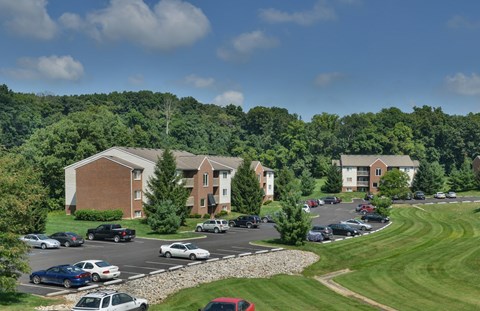 A parking lot with cars and a building in the background.