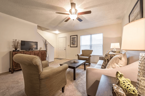 A living room with a brown chair and a brown coffee table.
