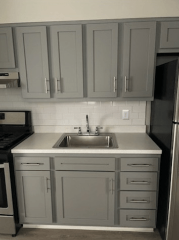 a small kitchen with a sink and cabinets