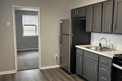 a kitchen with a sink and a refrigerator