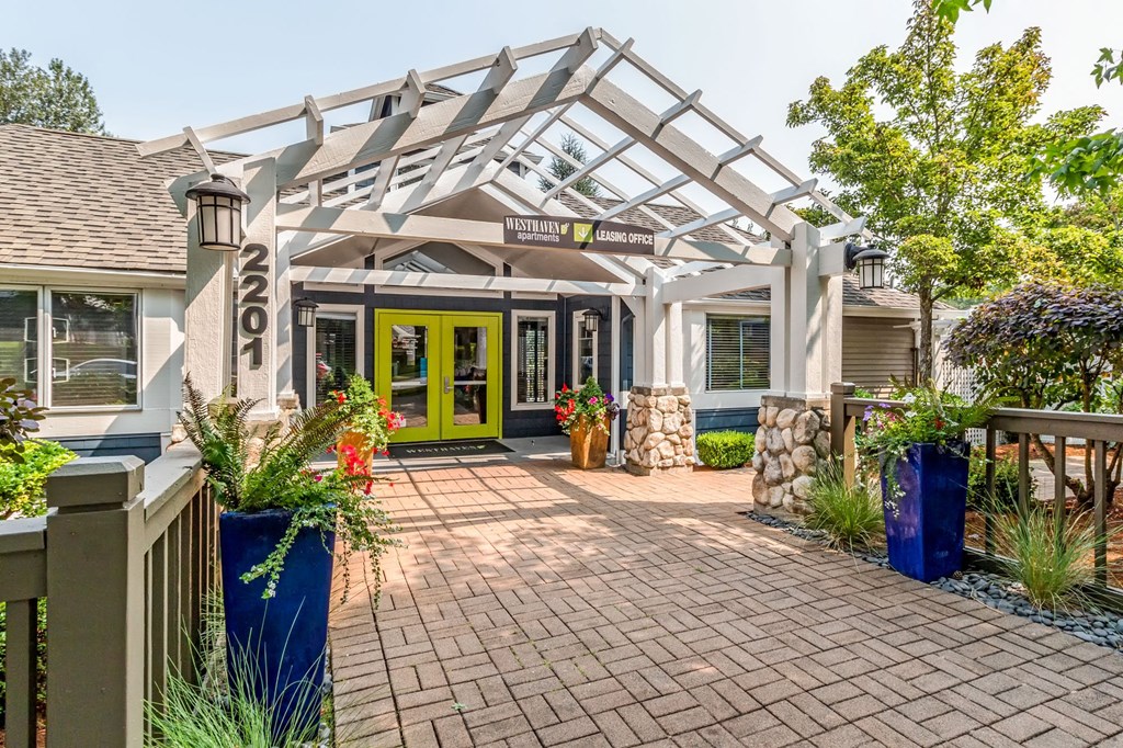 the front entrance of a house with a walkway and a greenhouse