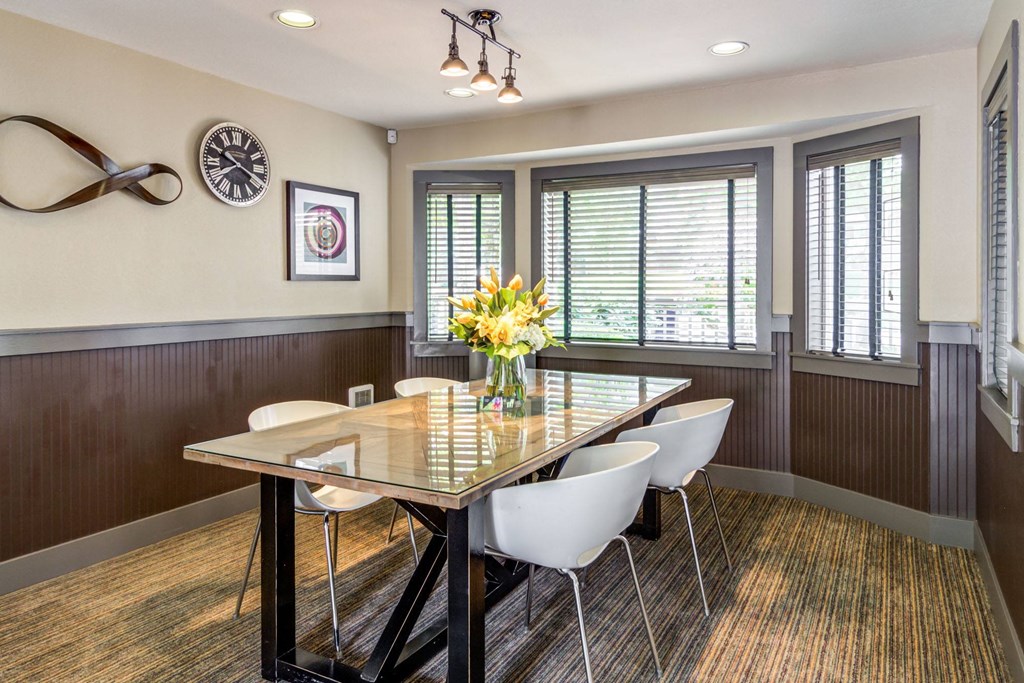a dining room with a table and chairs