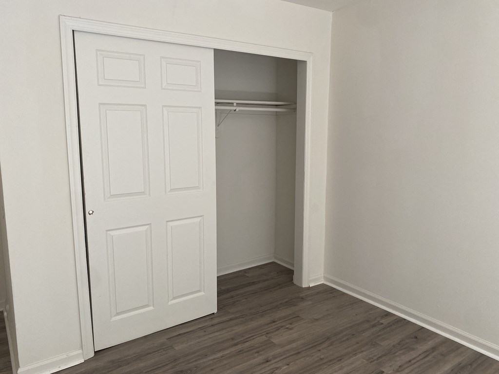 a room with a closet and a door to a closet