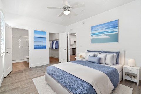 a bedroom with a bed and a ceiling fan