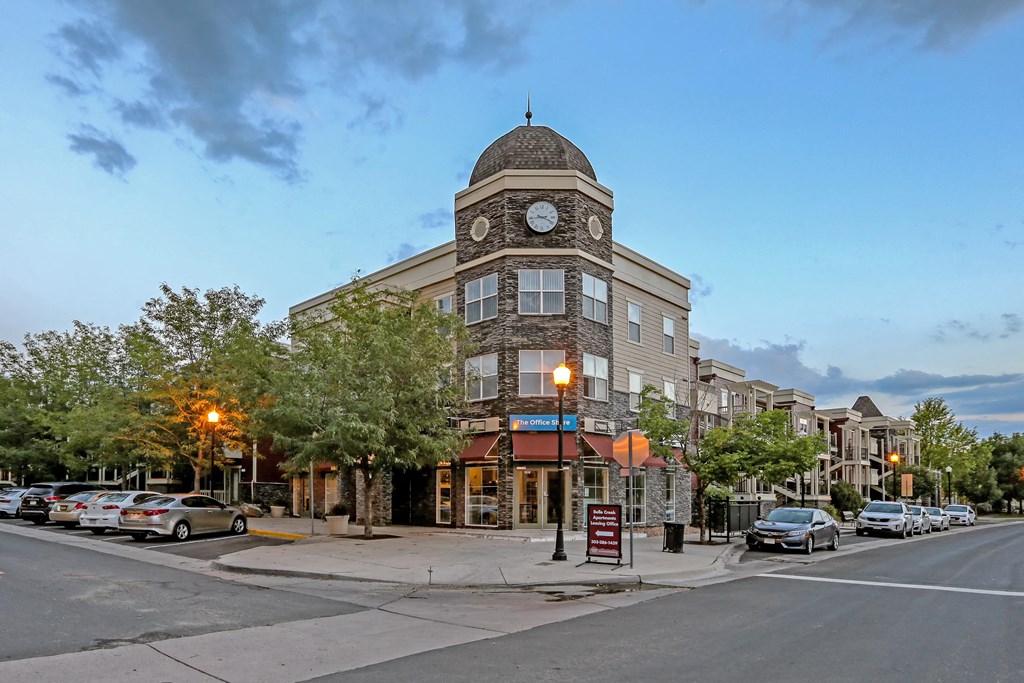 a building with a clock tower on the corner of a street
