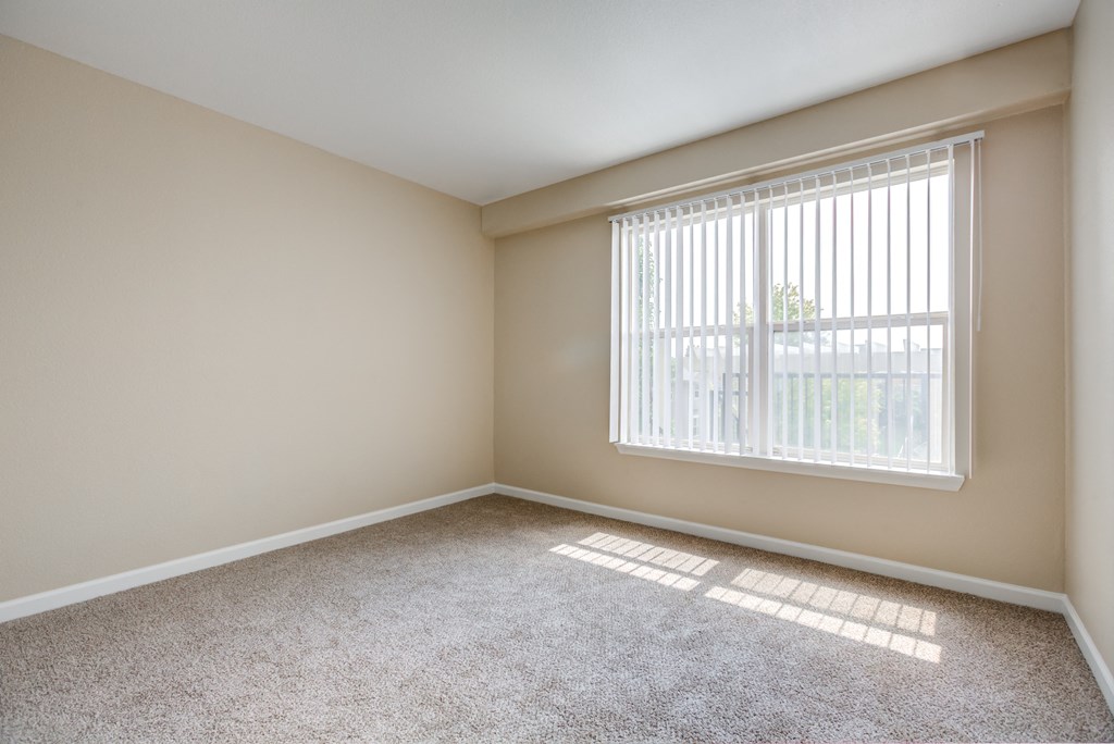 an empty living room with a large window