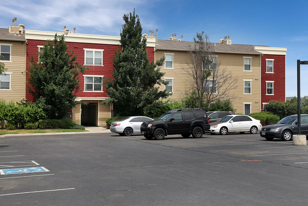 an apartment building with cars parked in front of it