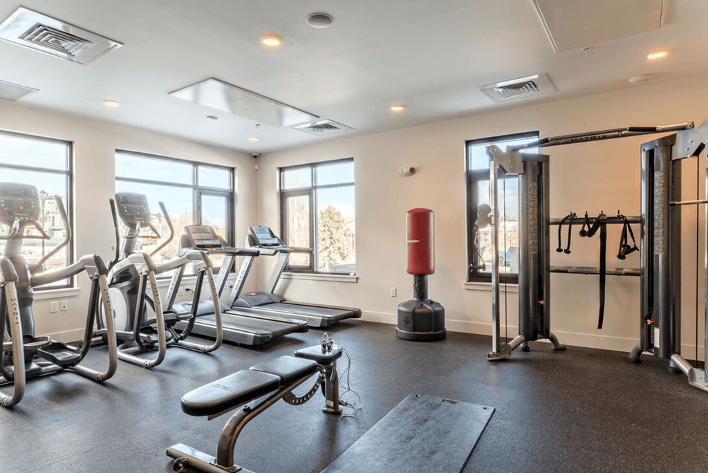 Gym with cardio equipment and a large window at Delo Apartments, Louisville, CO, 80027