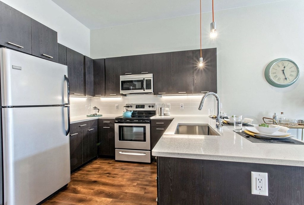 Kitchen with stainless steel appliances and white counter tops at Delo Apartments, Louisville, CO, Colorado, 80027