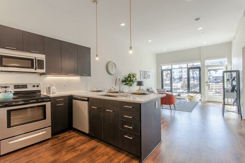 a kitchen with an island and a stove and a living room