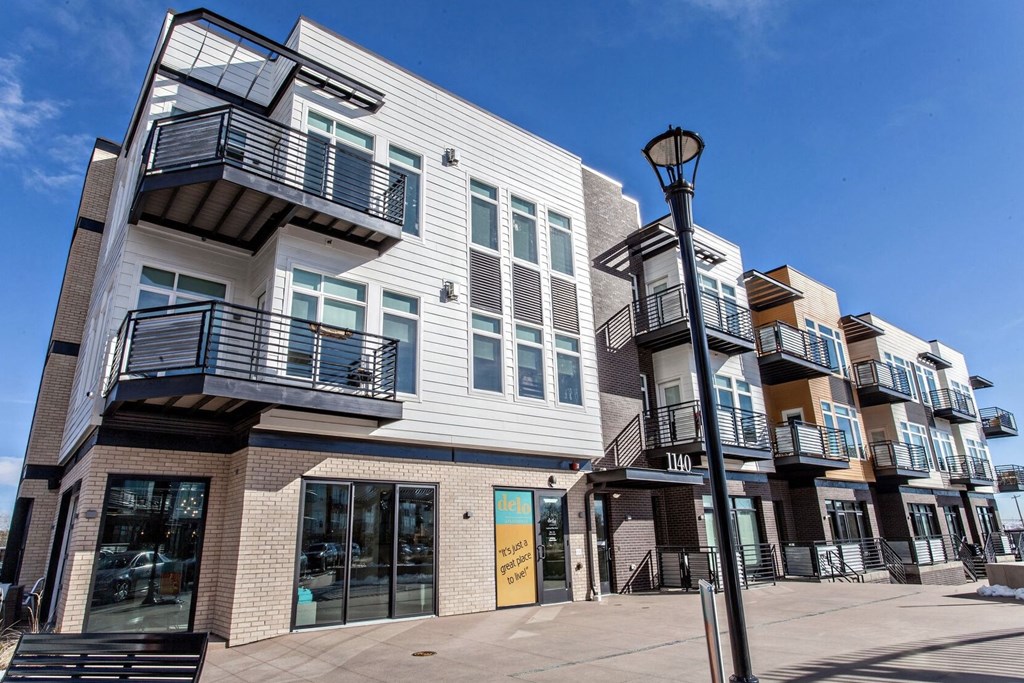 Building with balconies and a sidewalk at Delo Apartments, Louisville
