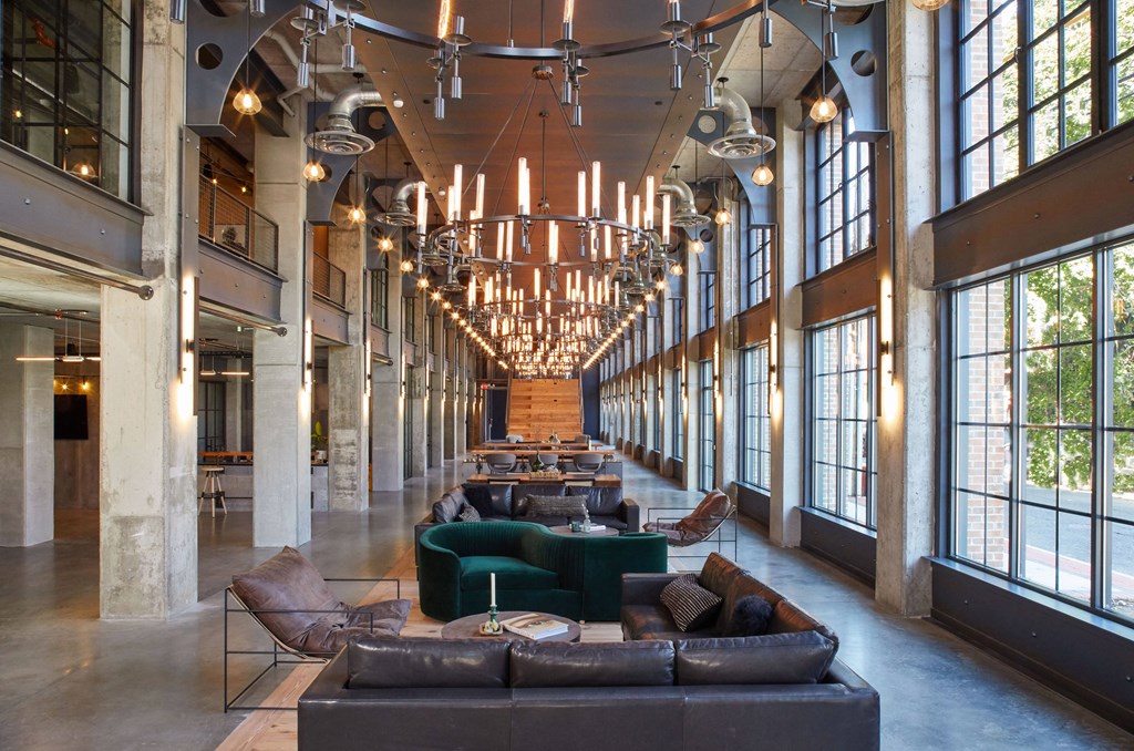 a large lobby with couches and chairs and chandeliers