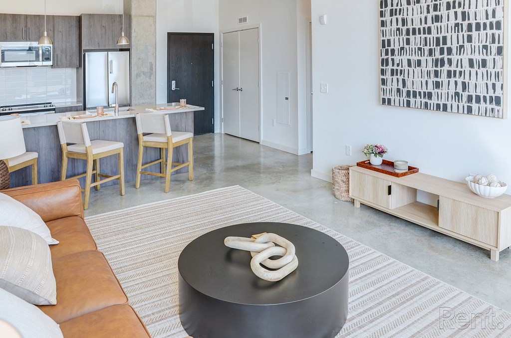A modern kitchen with a black table in the middle at The Anthem at Square 10 Apartments, New Haven, 06510
