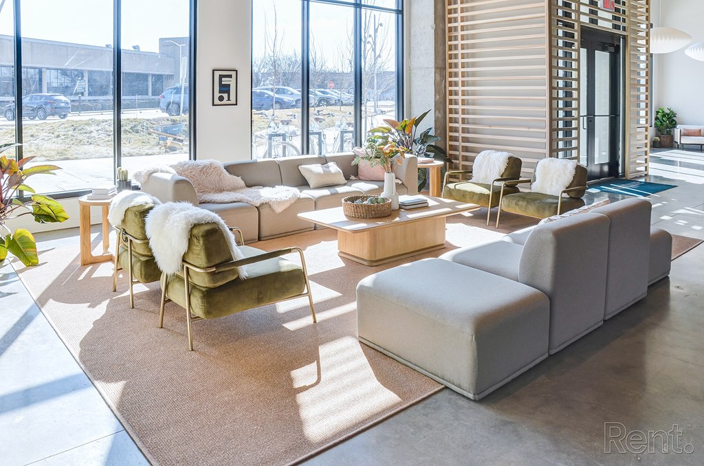 A living room with a couch, chair, and table at The Anthem at Square 10 Apartments, Connecticut, 06510