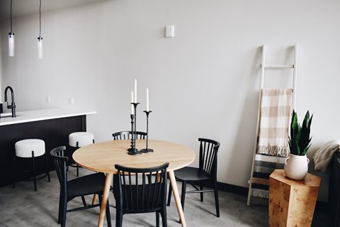 A dining room with a round table and chairs.