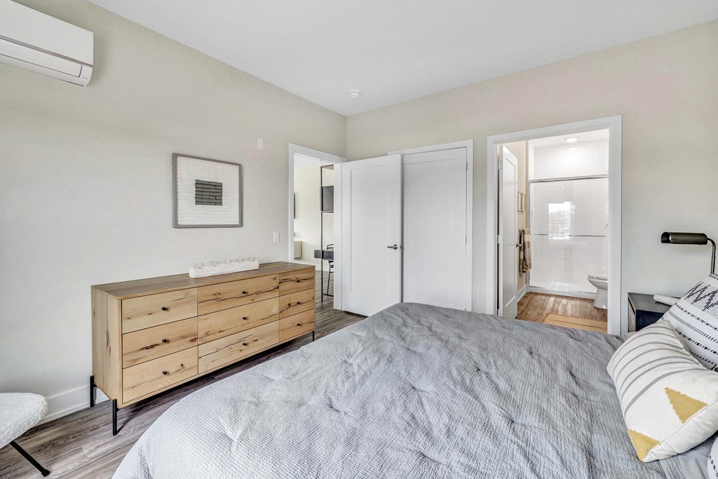 a bedroom with a bed and a dresser