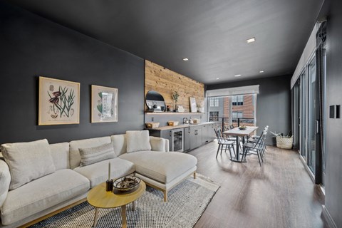a living room with a couch and a table and a kitchen
