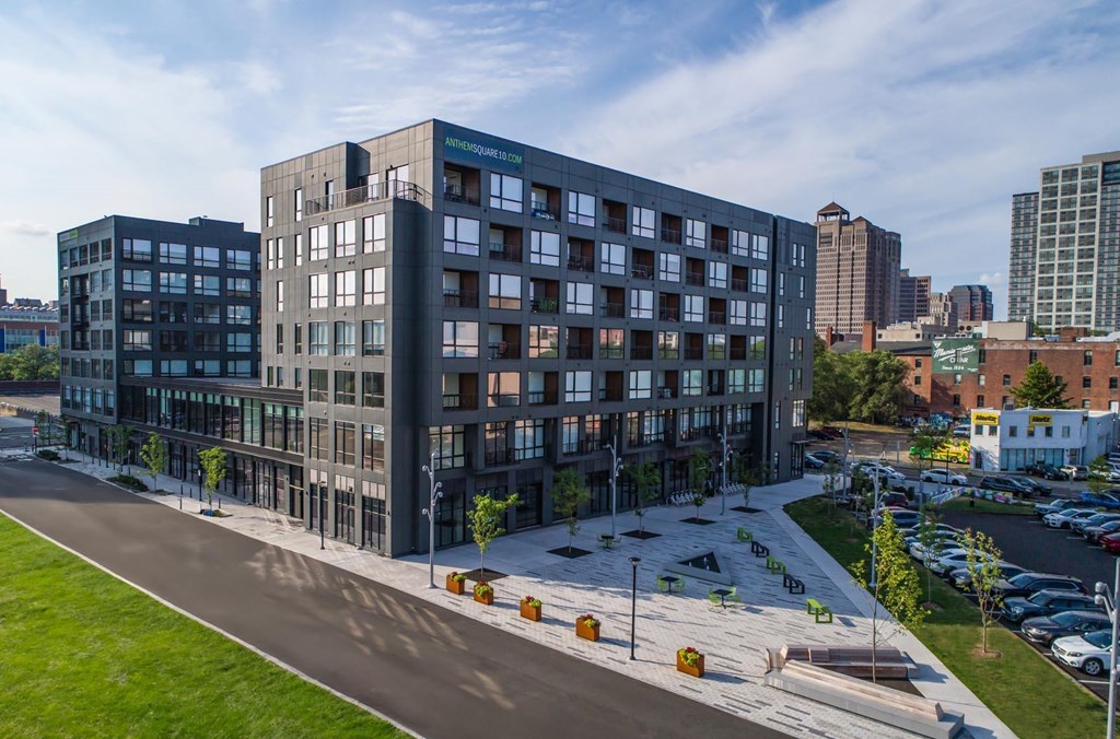 A modern multi-story building with a glass facade at The Anthem at Square 10 Apartments, New Haven, Connecticut