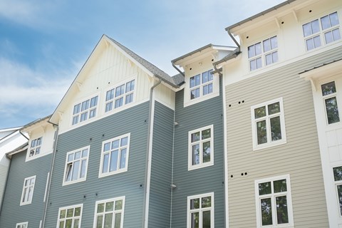 A modern building with a combination of grey and white exterior.
