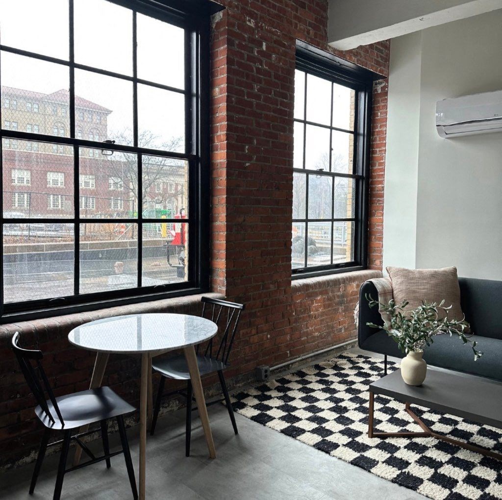 a small room with a table and chairs and a window at The 55 Elm Club Apartments, Hartford, CT