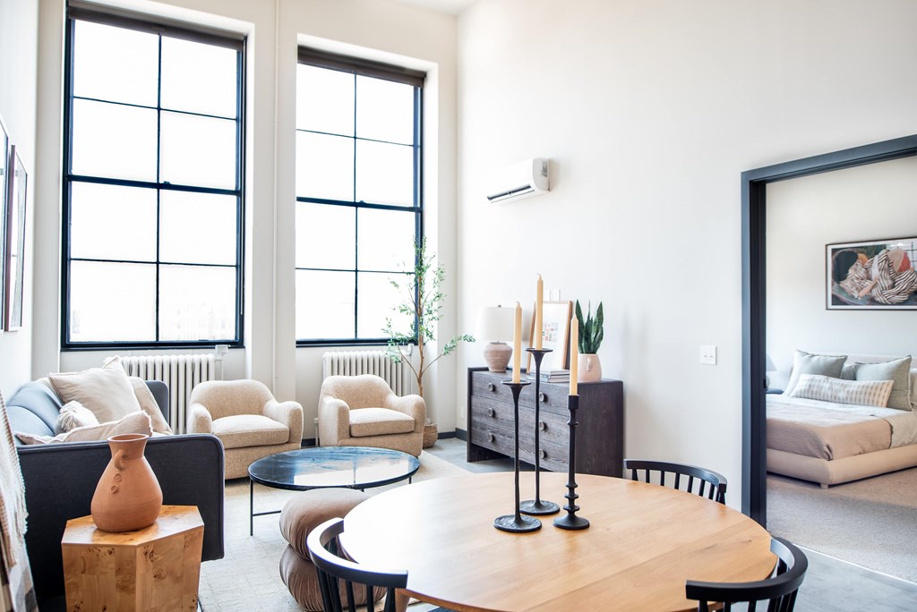 A living room with a wooden table and chairs.