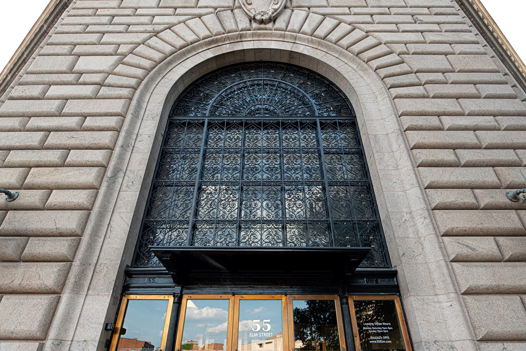 A building with a large arched window and a sign that reads "55".