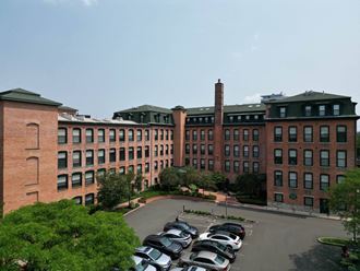 a large brick building with a chimney on top  at The Corset Factory, Connecticut, 06854 - Photo Gallery 3