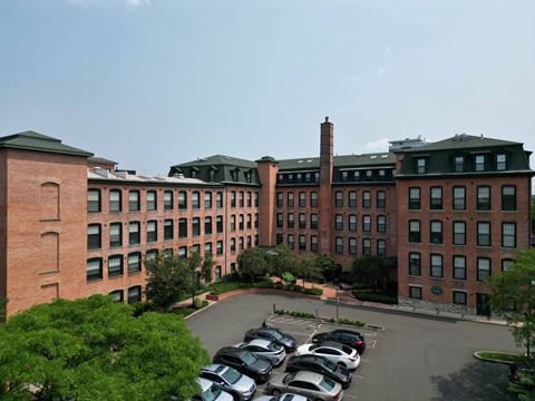 a large brick building with a chimney in the background  at The Corset Factory, Connecticut