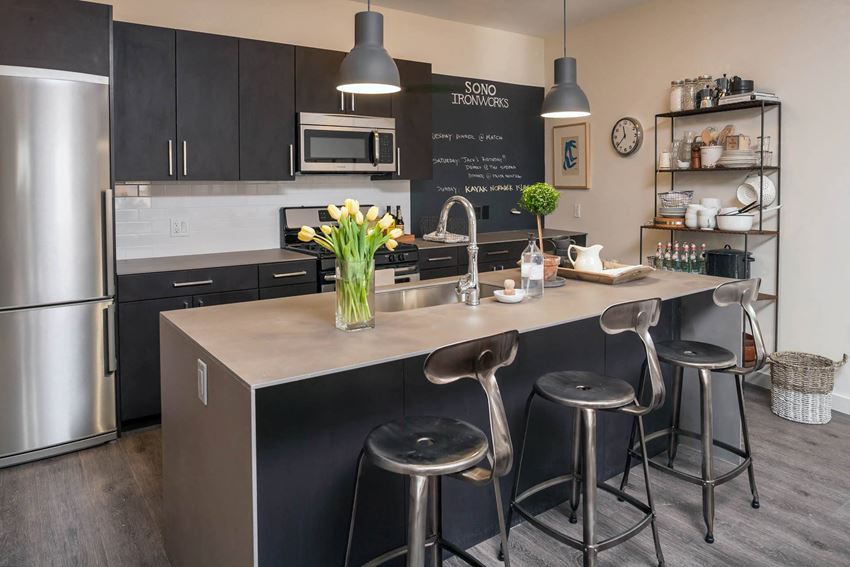 a kitchen with a large center island with three stools a kitchen with a large center island with three stools at Iron Works Sono, Norwalk, Connecticut - Photo Gallery