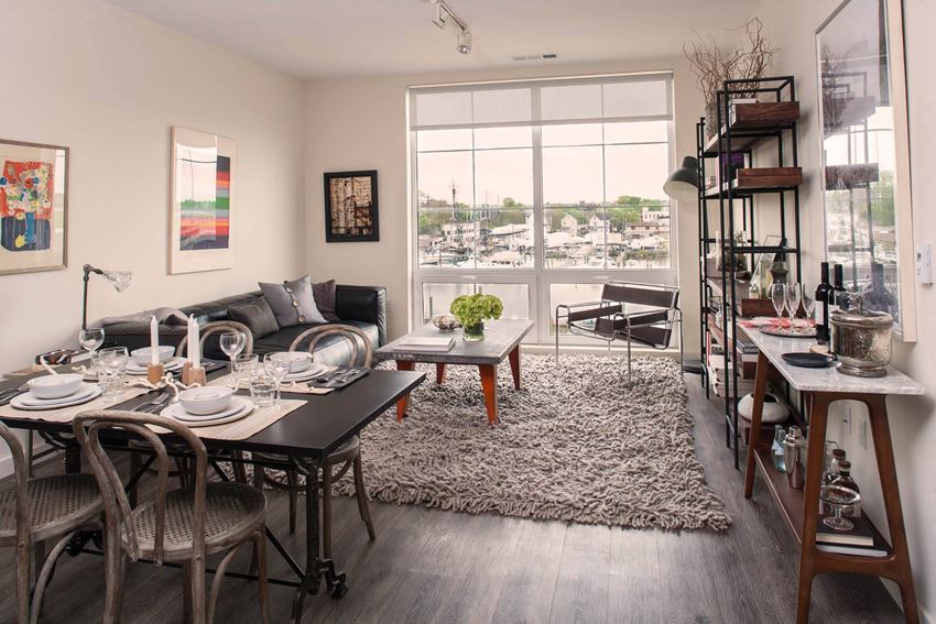 a living room with a table and chairs in front of a window a living room with a table and chairs in front of a window at Iron Works Sono, Norwalk, CT - Photo Gallery