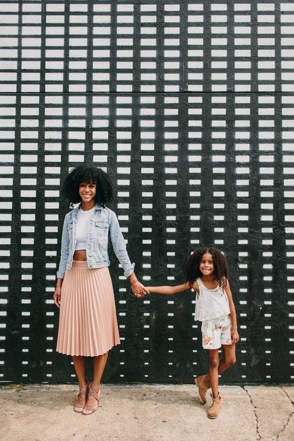 Woman and a child standing in front of a black and white wall  at Sono Central Residential, Norwalk, CT
