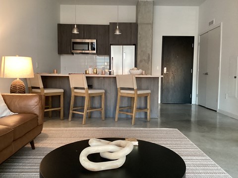 A modern living room with a black coffee table and a white sculpture on it at Anthem at Square 10 in New Haven, CT 06511
