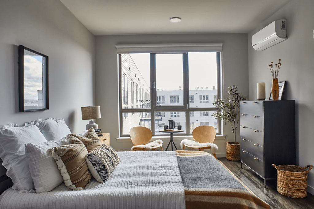 Bedroom with a bed and a large window at Sono Central Residential, Norwalk, CT
